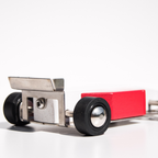 Small model car with red body and black wheels on a white background