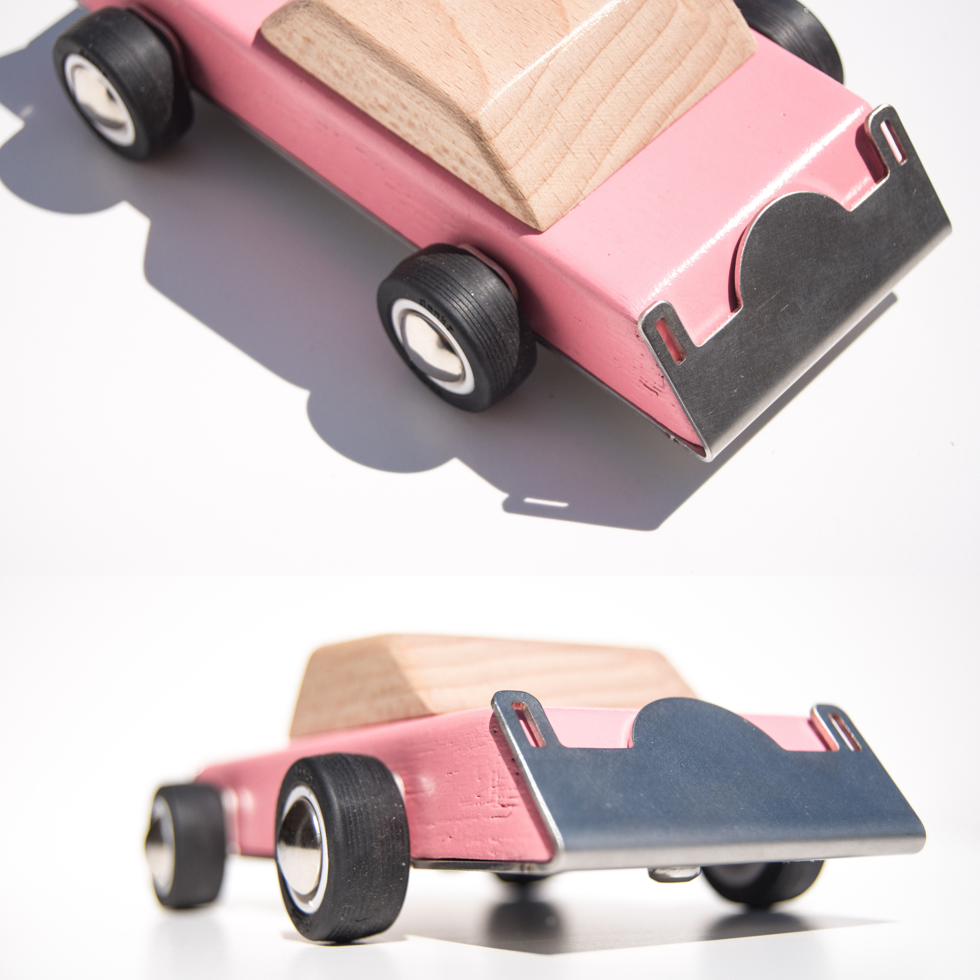 Pink wooden toy car features on a white background