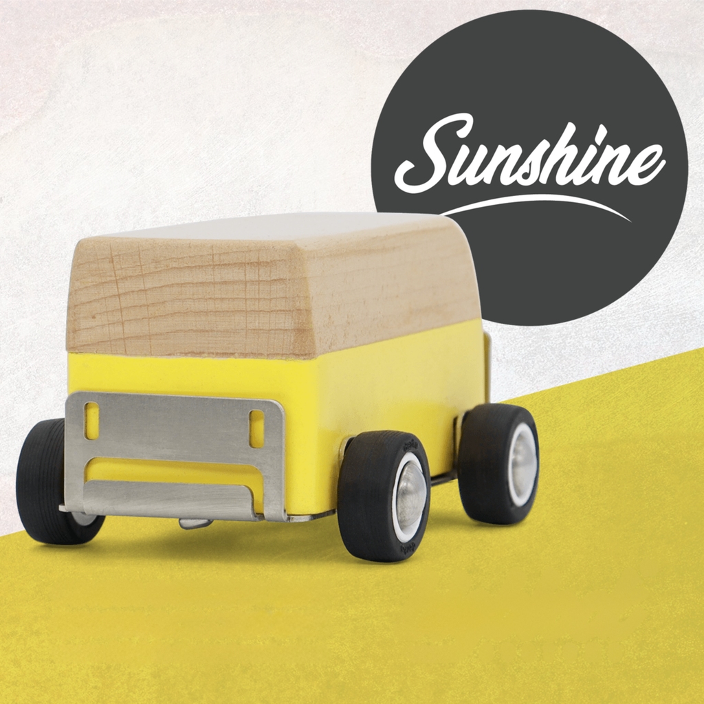 wooden toy bus with wooden top and yellow body on a yellow surface, branded 'Sunshine'.