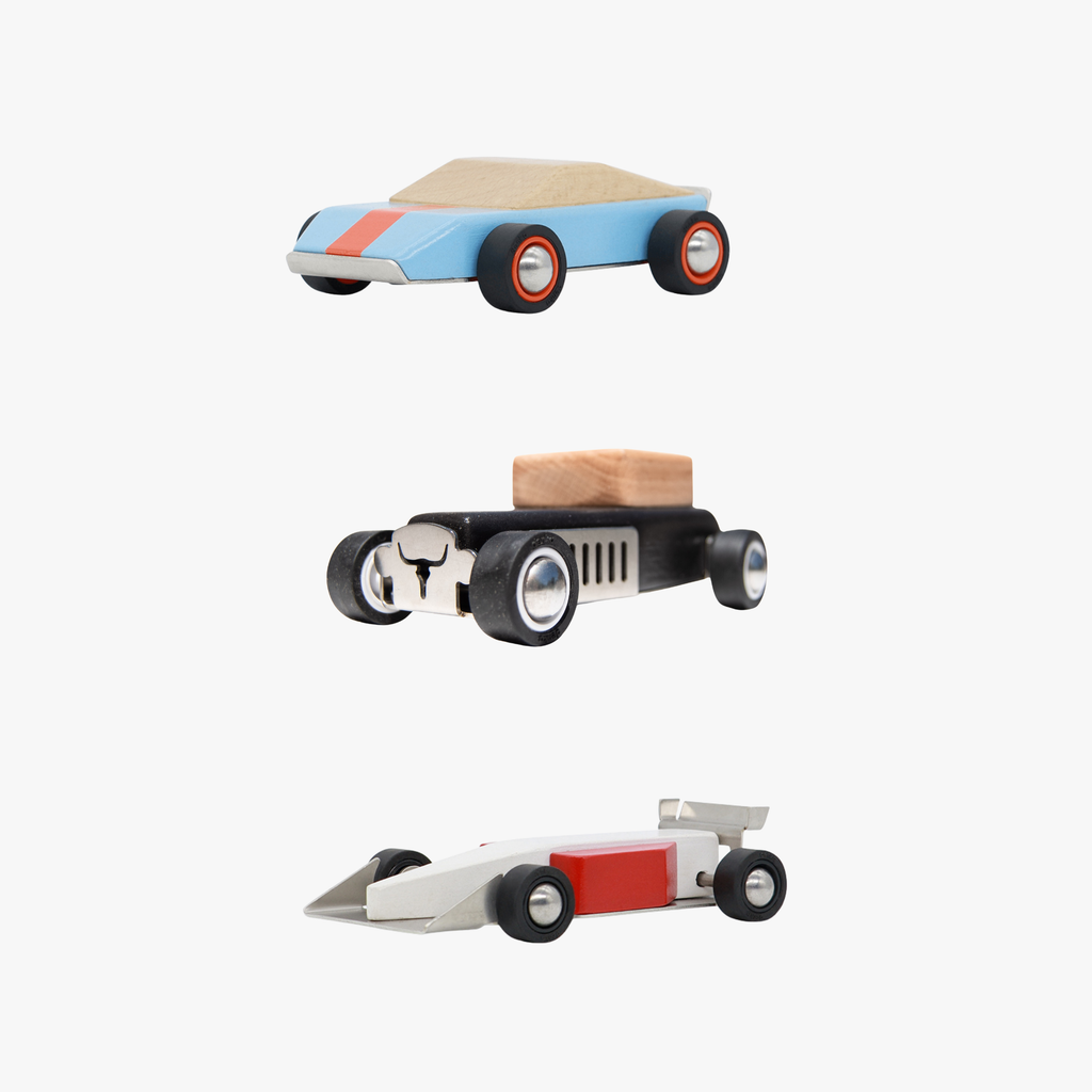 Three wooden toy cars on a white background