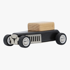 Wooden block on a black car-shaped stand with chrome accents on a white background