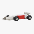 Toy Formula 1 car with a red block on a white background