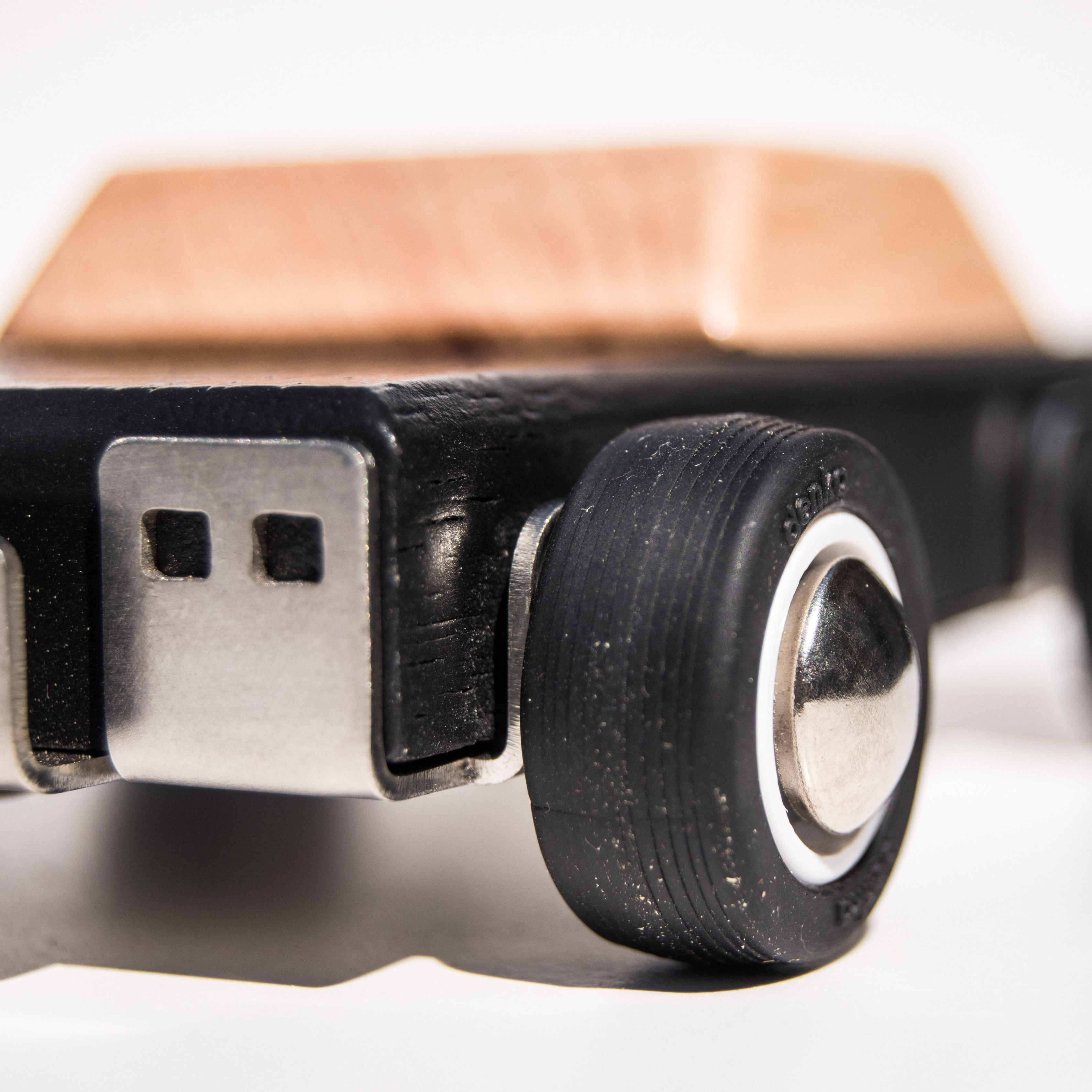 Close-up of a wooden toy car duke with a focus on the wheels.