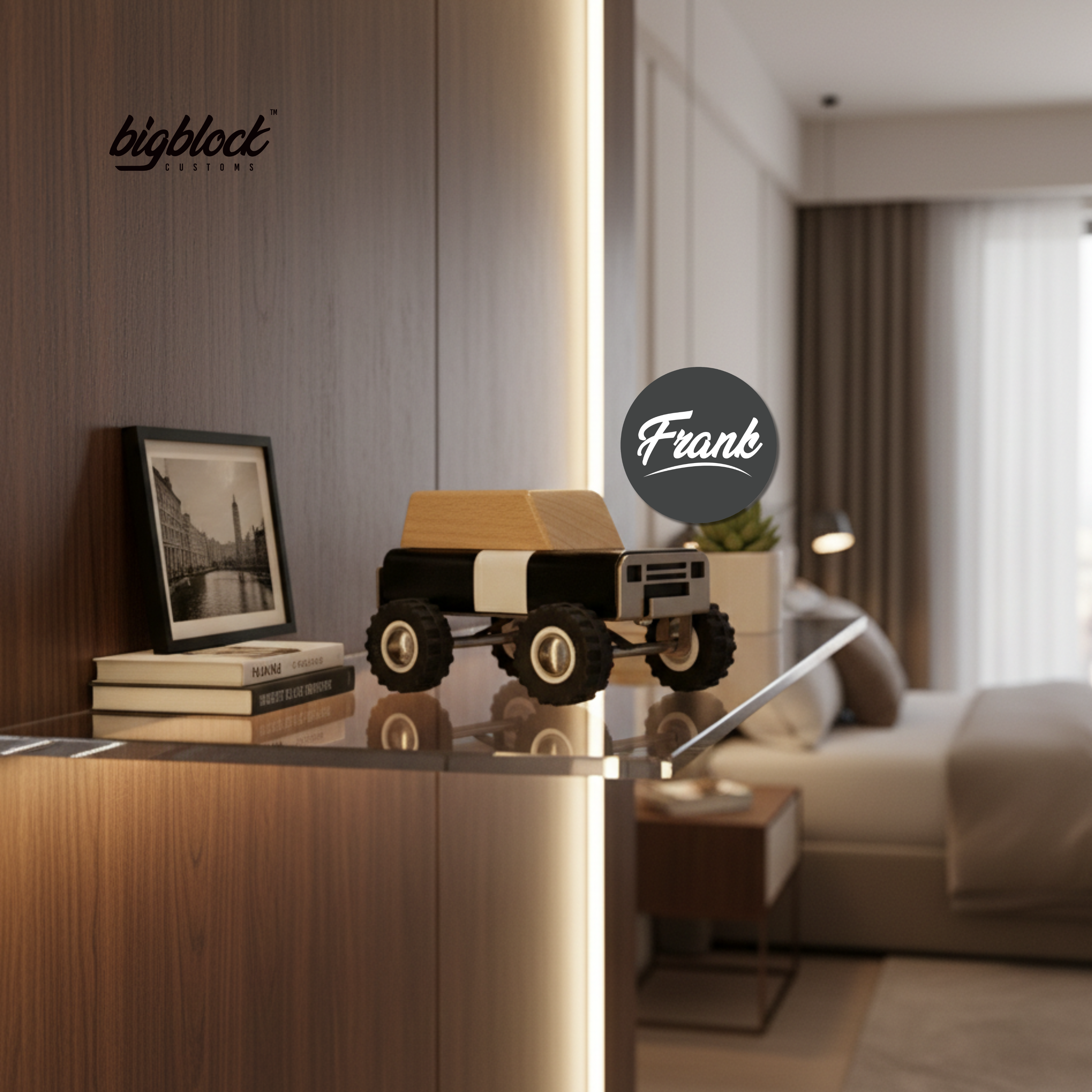 Model wooden toy truck on a reflective surface with 'bigblock' branding, blurred bedroom in the background