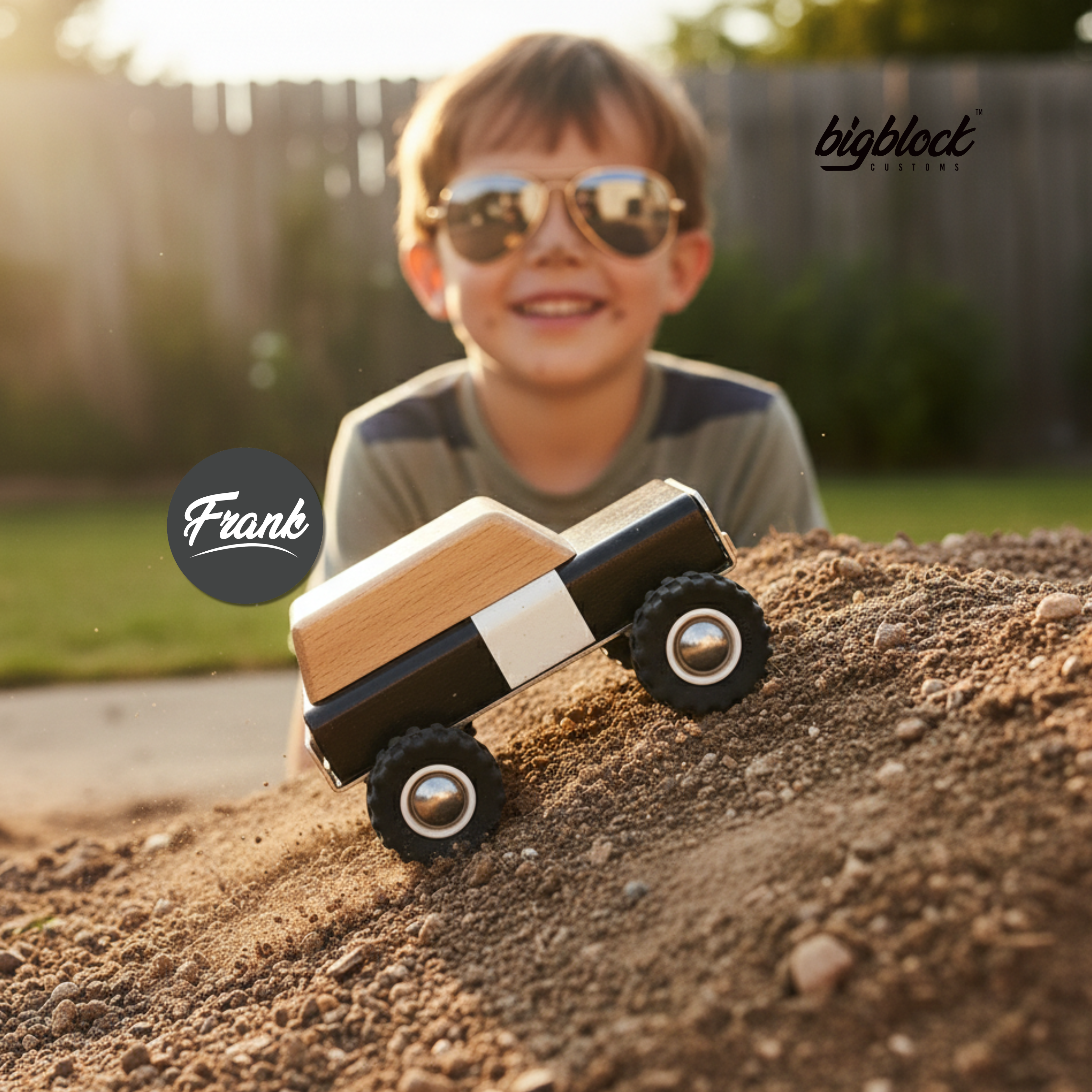 Child wearing sunglasses with a wooden toy truck in the foreground, blurred background