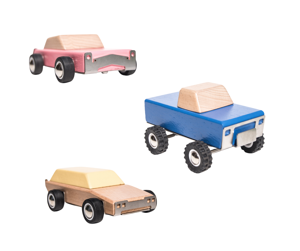 Three toy cars in pink, blue, and brown on a white background