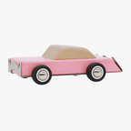 Pink wooden toy car with a white interior on a white background