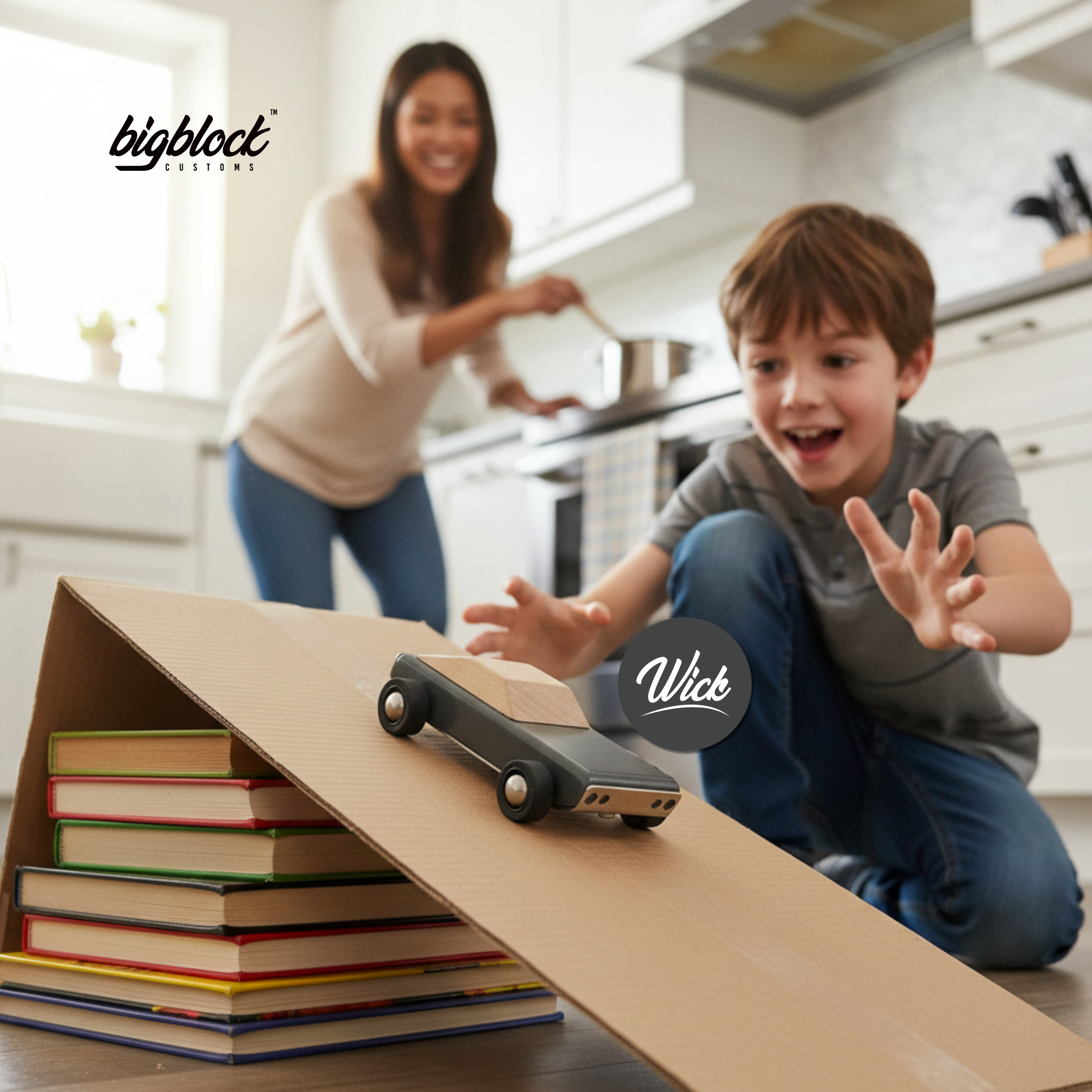 Child playing with a wooden toy car on a ramp made of books in a kitchen, with 'bigblock' branding.