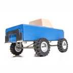 Blue toy truck with a wooden block on a white background