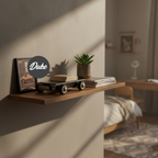 Wooden shelf with decor items in a room setting, featuring the brand 'Duke'.