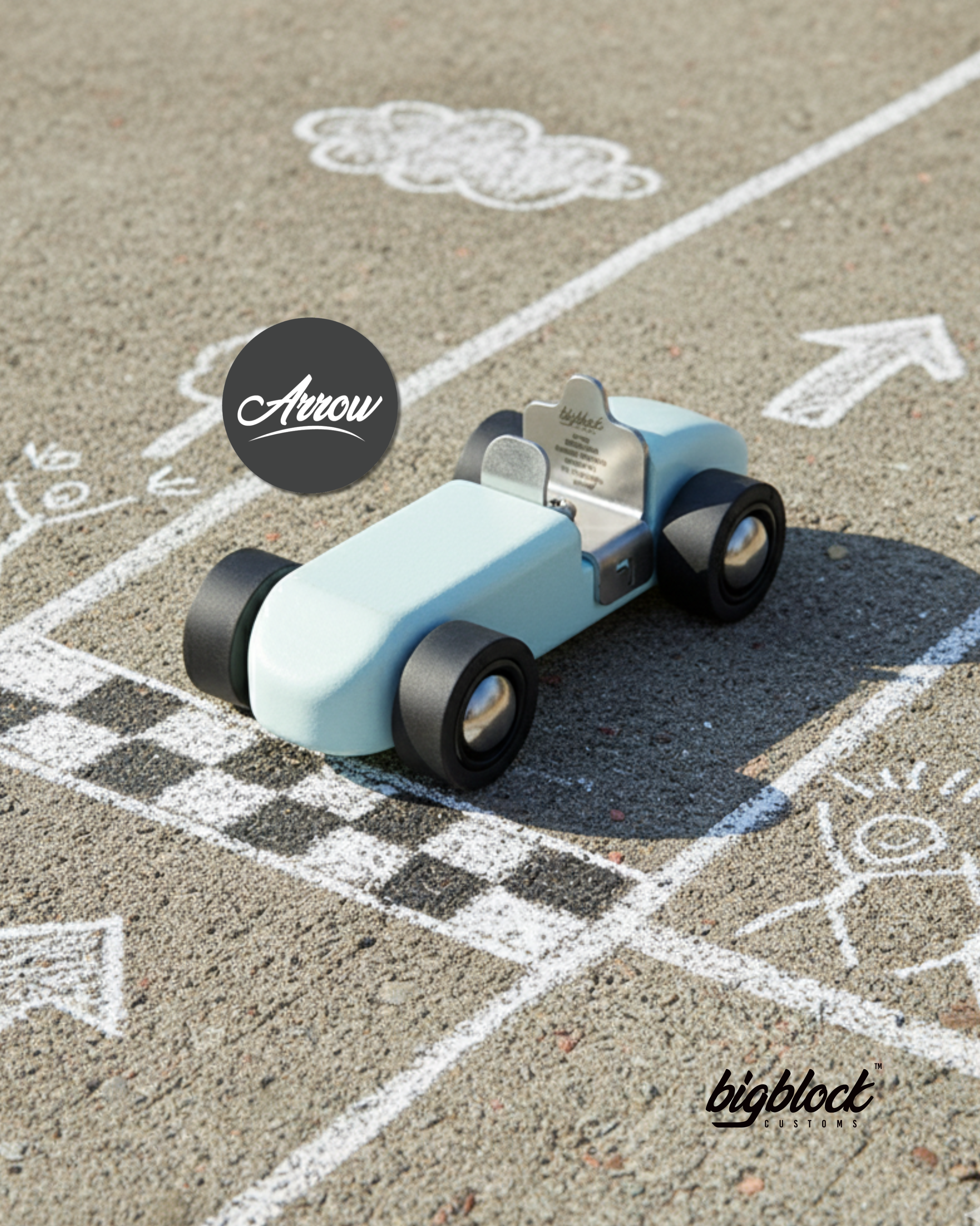 Toy car on a chalk-drawn track with 'Arrow' and 'bigblock' branding.