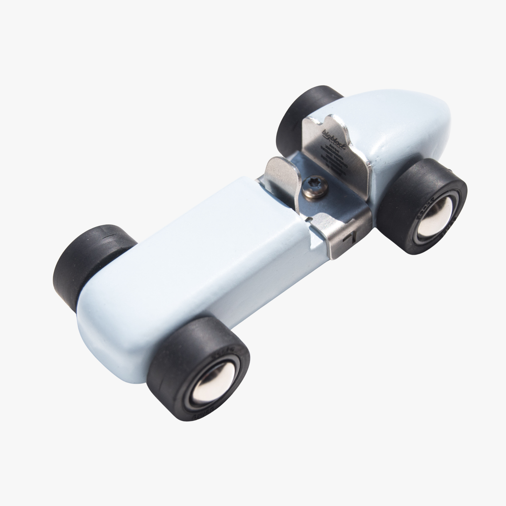 Wooden toy car with a white body and black wheels on a white background